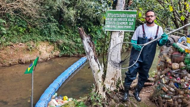 Diego segurando uma redecomo criar site de apostasfrente ao rio e barreira que criou