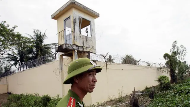 A Vietnamese policeman stands watch outside the Phuoc Co jail on the outskirts of the southern coastal town of Vung Tau