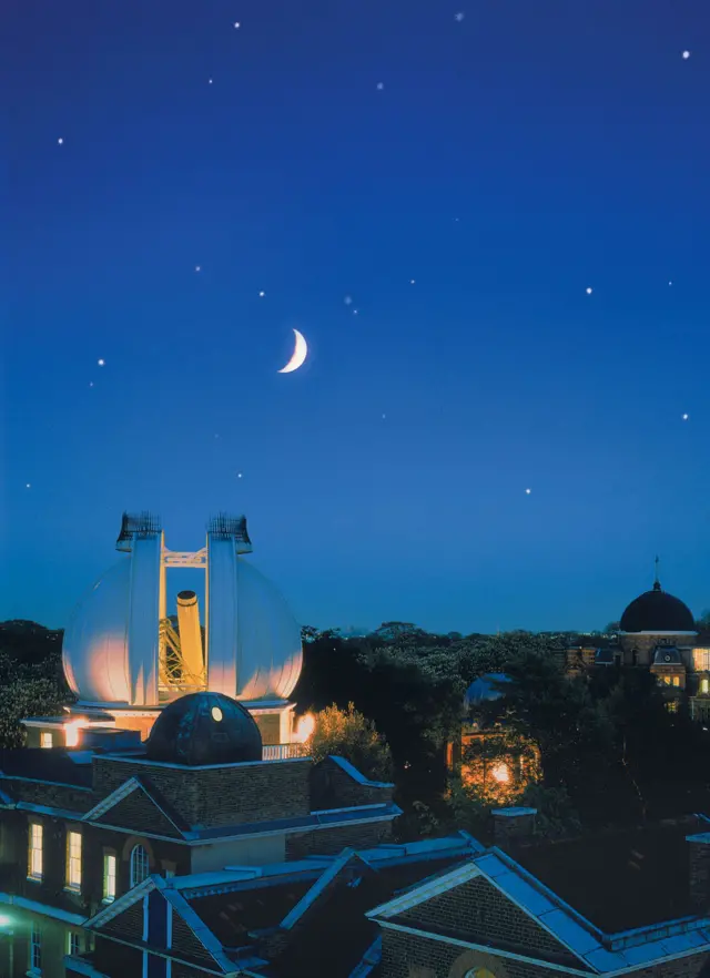 Royal Observatory seen by night with moon in background