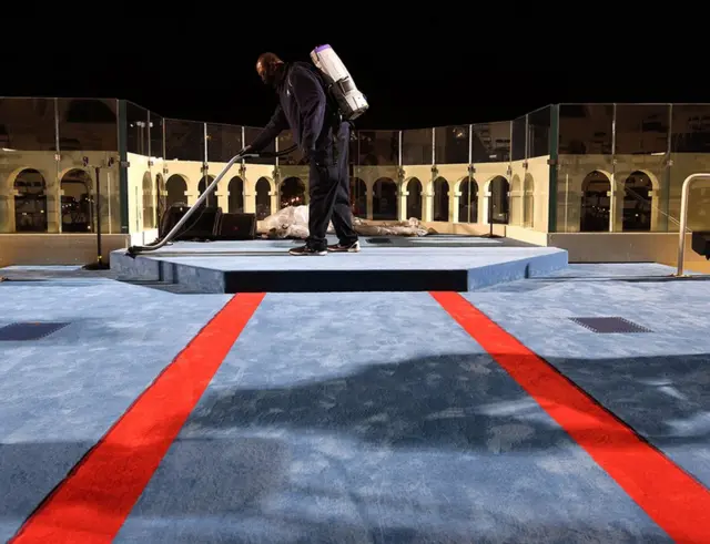 A man hoovers the carpet at the Capitol