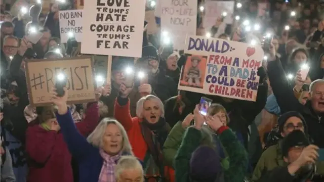 متظاهرون يحملون لافتات