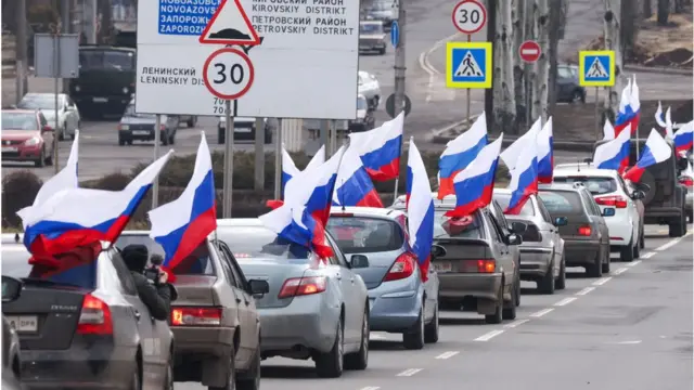 Vehicles carrying Russian flags are pictured in central Donetsk as city residents celebrate the recognition of the Donetsk People's Republic by Russia.