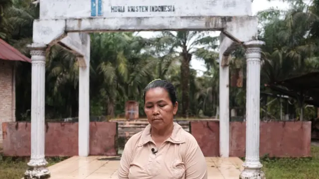 Masarani Berutu di depan gereja Huria Kristen Indonesia Sukamakmur, Aceh Singkil.