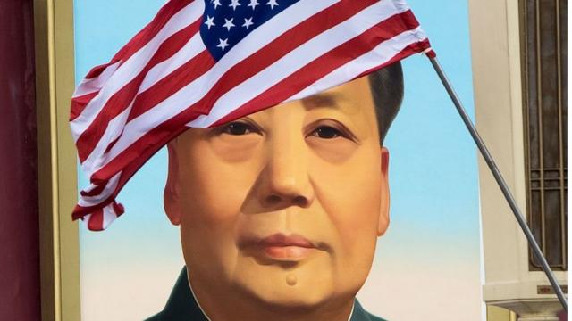 A US flag in front of the portrait of Mao Zedong