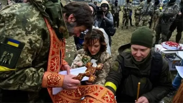 Valery e Lesya, ambos vestidos com uniforme camuflado, realizaram uma pequena cerimônia