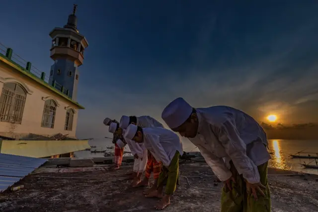 A large group of Indonesian Muslims pray at Al-Mabrur mosque in Surabaya, Indonesia