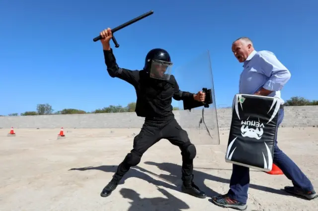 A member of security forces takes part in a training session arranged by a security company in Tajoura suburb of Tripoli.