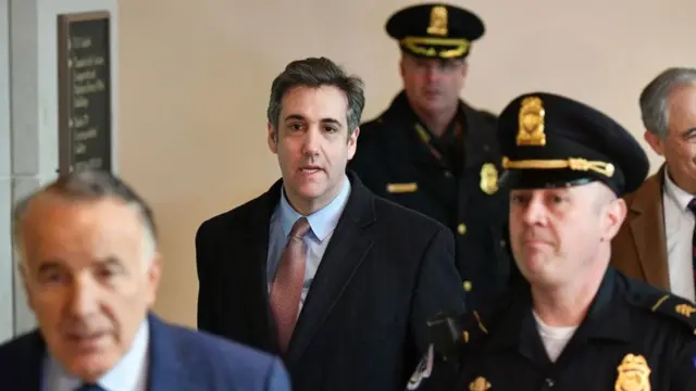 Cohen walks with lawyers and police