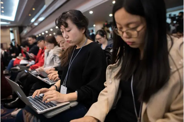 Journalists take notes as the Guangdong delegation meets at a hotel during the National People"s Congress, China"s legislature, in Beijing on March 6, 2018. President Xi Jinping"s bid to rule for life has stunned many people in China. It left retired state-owned newspaper editor Li Datong cursing in a foreign language in a crowded mall. / AFP PHOTO / NICOLAS ASFOURINICOLAS ASFOURI/AFP/Getty Images