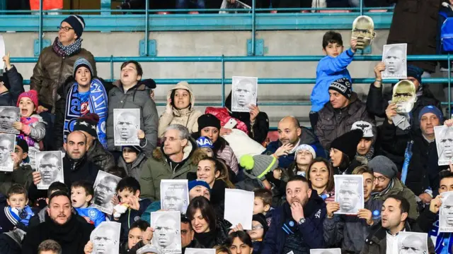 Napoli fans with pictures of Kalidou Koulibaly