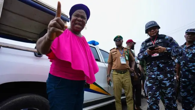 Woman stand wit police