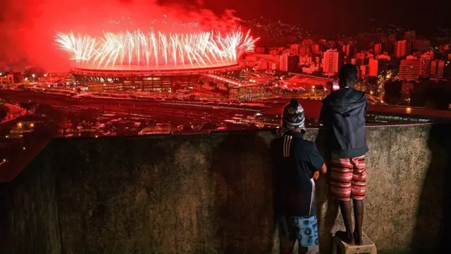 Children from Mangueira favela watch fireworks over Maracana Stadium during the Rio 2016 Olympics Games closing ceremony in Rio de Janeiro on August 21, 2016