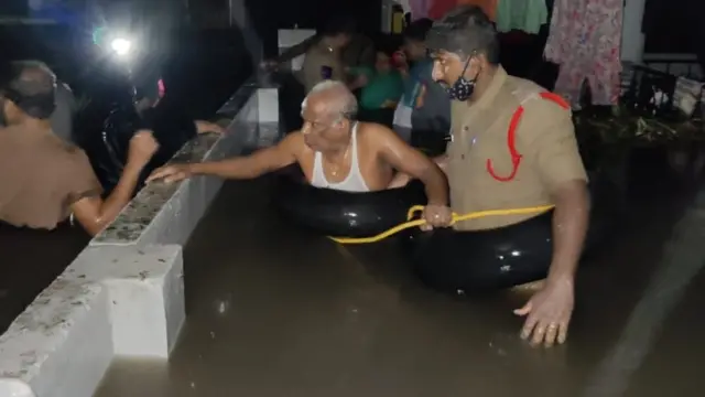 నీట మునిగిన ఇంటి నుంచి వయోధికుడిని రక్షిస్తున్న పోలీసులు