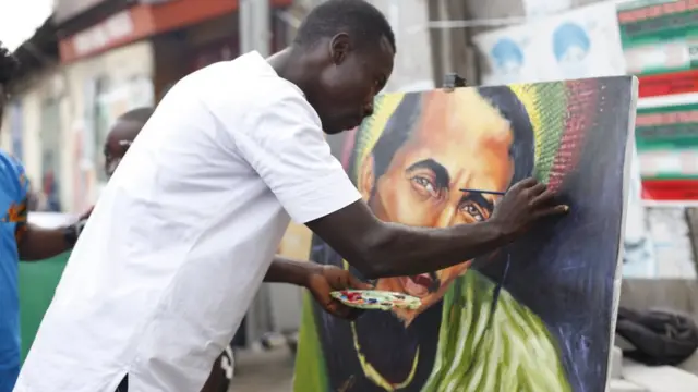 Ghanaian Artist Ibrahim Botchwey at work Chale wote street art festival in Accra-Ghana
