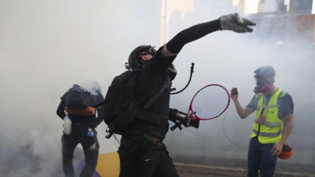 Protester throws back tear gas canister - 1 October