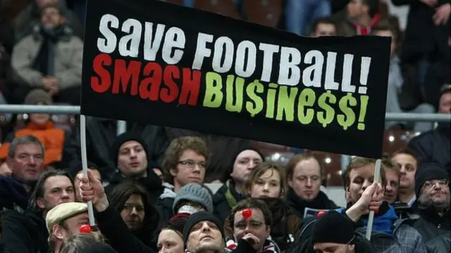 St Pauli fans display a banner reading: Save Football Smash Busine$$