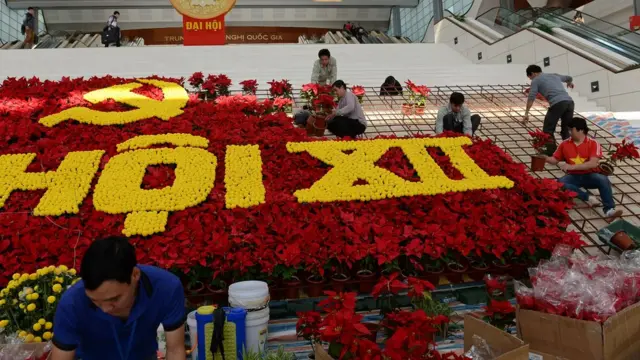 Workers place flowers as they set up decorations at the My Dinh National Convention Center, the main venue of the upcoming Vietnam Communist Party's 12th National Congress, in Hanoi on January 18, 2016.