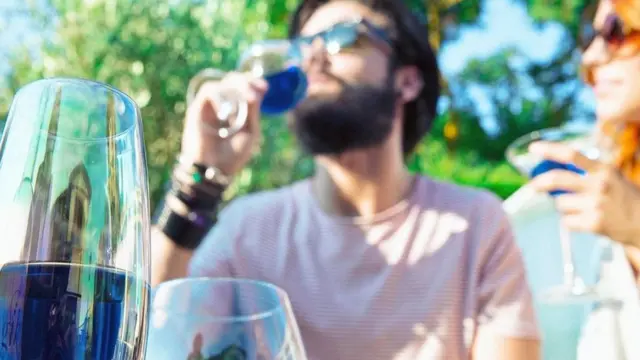 Чоловік з келихом синього вина