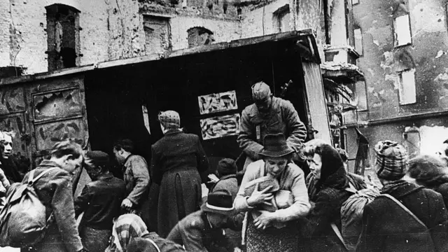 Soviet soldiers hand out bread to civilians in Berlin 1945