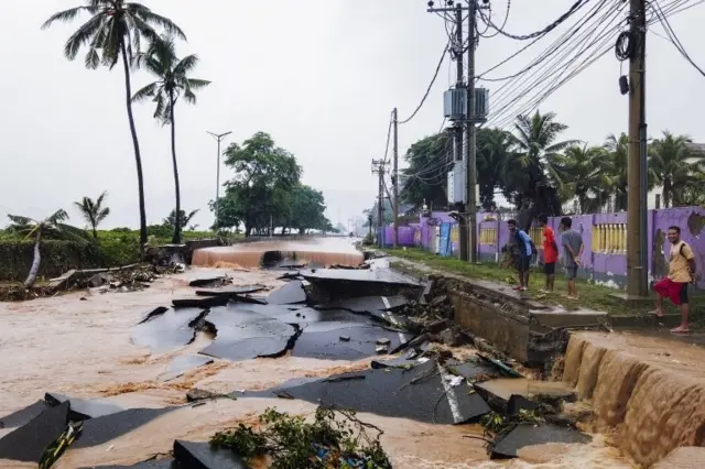 People look at the floodwaters in Dili, East Timor, also known as Timor-Lester, 04 April 2021