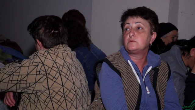 গোলাবর্ষণ এড়াতে সেলারে আশ্রয় নেওয়া কয়েকজন শরণার্থী।