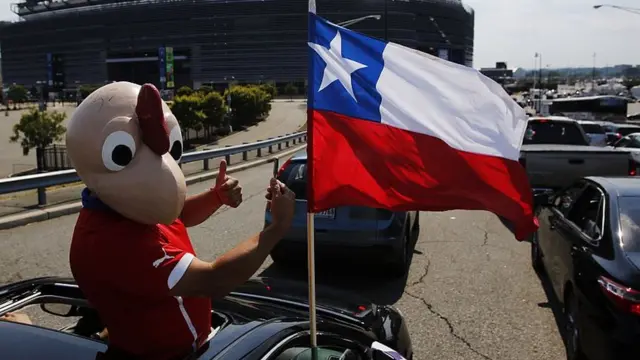 Un hombre vestido en el disfraz de Condorito con la bandera de Chile.