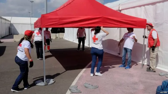 Red Cross volunteers mount a tent at the point of arrival of refugee vessel Aquarius and two other Italian ships expected tomorrow at the port of Valencia, Spain, June 16, 2018