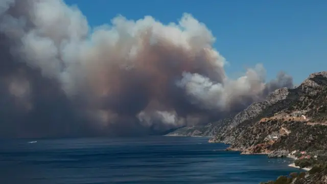 Flames can be seen rising above an island.