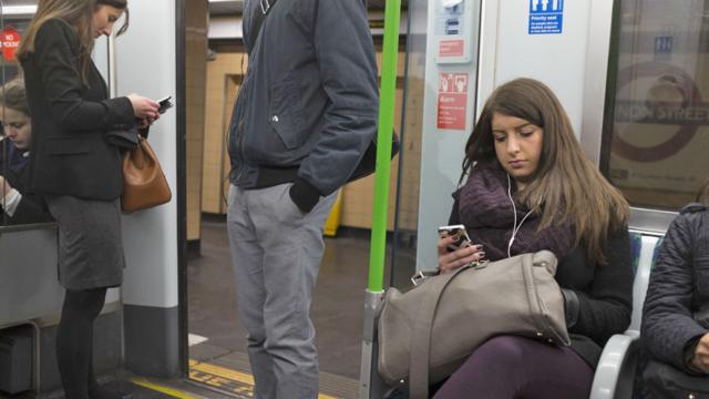 Commuters on mobiles