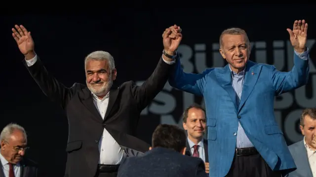 Turkey's President Recep Tayyip Erdogan and Zekeriya Yapicioglu, leader of the Free Cause Party (HUDA-PAR), greet supporters at a rally