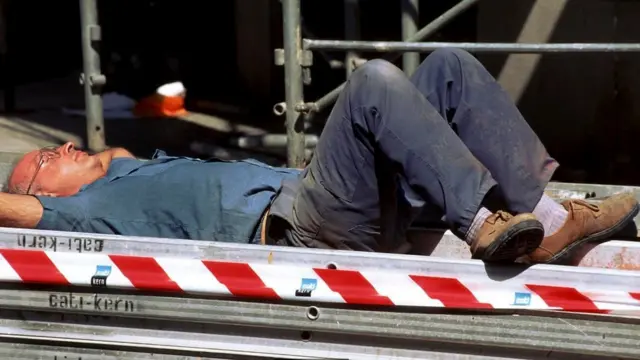 Un trabajador de la construcción aparentemente tomando una siesta