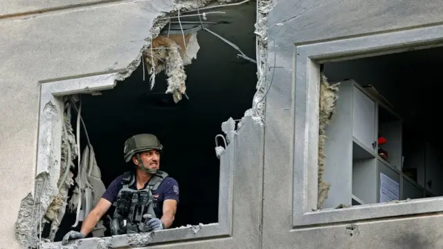 An Israeli sapper checks a damaged apartment in the southern Israeli city of Ashkelon on May 11, 2021, after rockets were fired by the Hamas movement from the Gaza Strip towards Israel