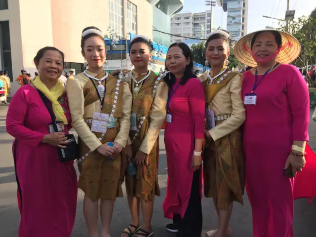 (Từ trái sang) Bà Trần Thị Môn, Sài Gòn; bà Trần Thị Đãi và bà Đà Nguyễn, Ninh Bình, chụp chung ảnh với các giáo dân Myanmar trước giờ Giáo Hoàng cử hành Thánh Lễ tại sân vận động Quốc gia ở Bangkok 21/11