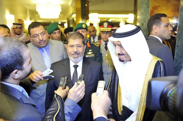 Egyptian President Mohamed Morsi (C) speaks to reporters alongside Saudi Crown Prince Salman bin Abdulaziz (R) upon arrival in Jeddah on July 11, 2012. Morsi is on his first foreign trip since taking office. AFP/STR (Photo credit should read -/AFP/GettyImages)