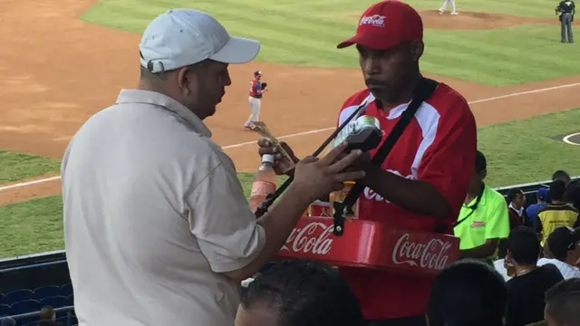 Un aficionado paga una bebida con tarjeta