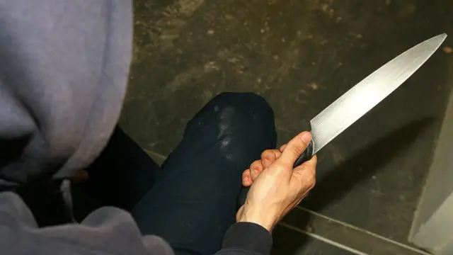 Boy holds knife