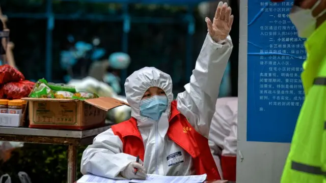 MARCH 16 2020: A government worker calls the next-in-line residents coming to claim their orders of grocery in a community in Wuhan in central China's Hubei province