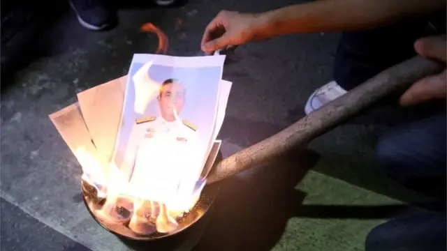 Protesters burn a picture of Thailand Prime Minister Prayuth Chan-ocha during a pro-democracy rally demanding the prime minister to resign and reforms on the monarchy, in Bangkok, Thailand, November 27, 2020.