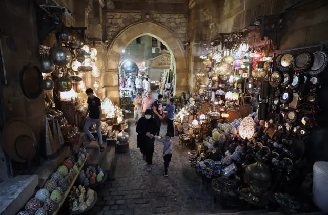 People walk in Khan al-Khalili bazaar in old Cairo, Egypt, 27 September 2021, as the world marks the United Nations (UN) World Tourism Day.