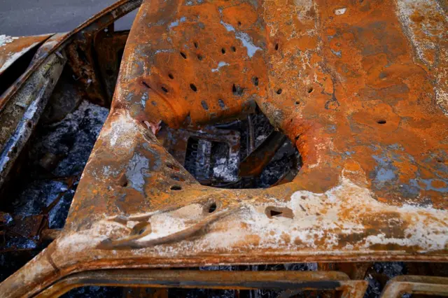 Shrapnel damage in a car roof in Kharkiv (Joel Gunter/BBC)