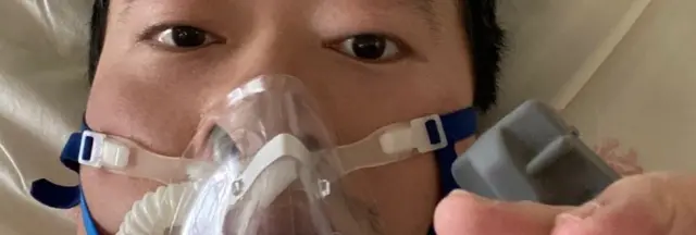 Dr Li shares a picture of himself in a mask from his hospital bed in Wuhan on Friday
