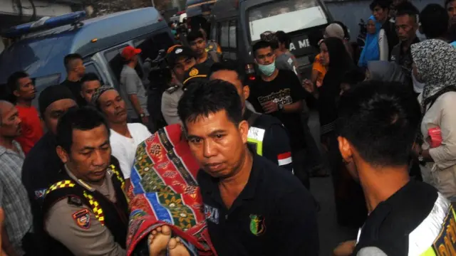 Anggota kepolisian mengangkat jenazah salah satu korban kapal motor Arista yang tenggelam di Rumah Sakit Jala Ammari, Makassar, Sulawesi Selatan, Rabu (13/6).