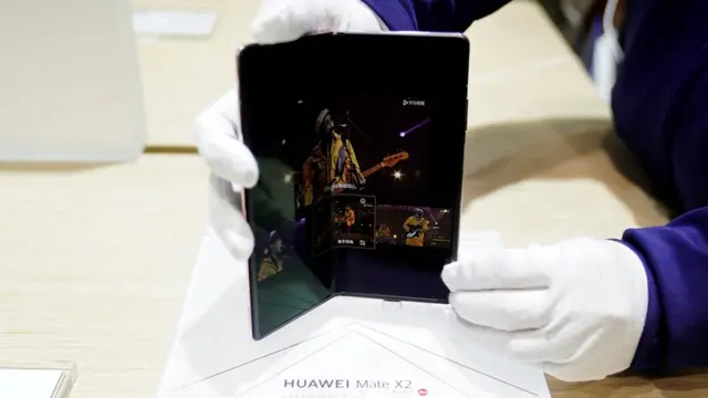 A staff member showcases Huawei's new 5G Mate X2 foldable phone at the Mobile World Congress (MWC) in Shanghai, China February 23, 2021.