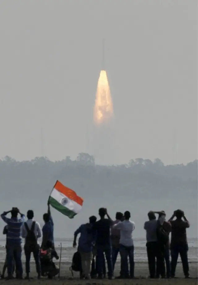 Indian onlookers watch the launch of the Indian Space Research Organisation (ISRO) Polar Satellite Launch Vehicle (PSLV-C37) at Sriharikota on 15 February 2017.