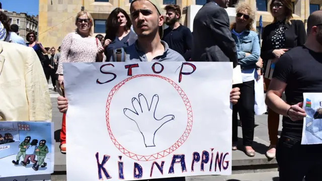 Участник акции протеста в Тбилиси