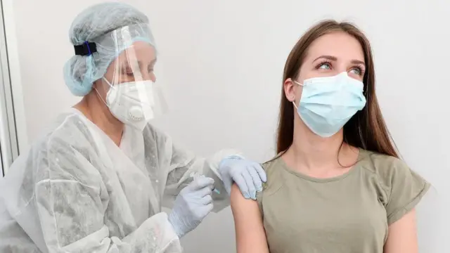 A Russian woman receives a coronavirus vaccination