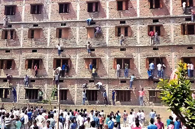 2015లో బిహార్‌లో పరీక్షలు రాస్తున్న తమ పిల్లలకు జవాబులు అందించటానికి వారి తల్లిదండ్రులు, స్నేహితులు స్కూల్ గోడలు ఎక్కిన దృశ్యం