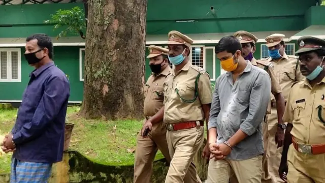 Forest officials take Sooraj and Suresh into custody.