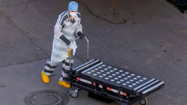 Inmate helping move bodies