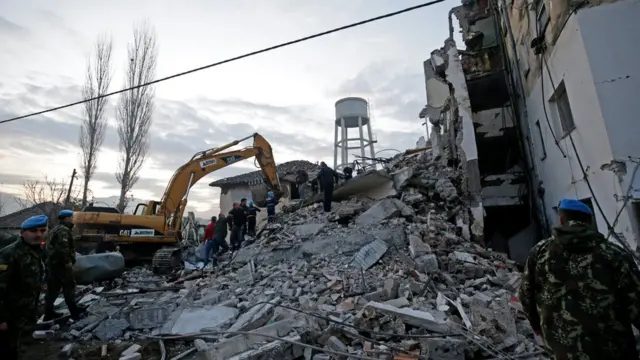 Emergency workers at the scene of a collapsed building in Albania